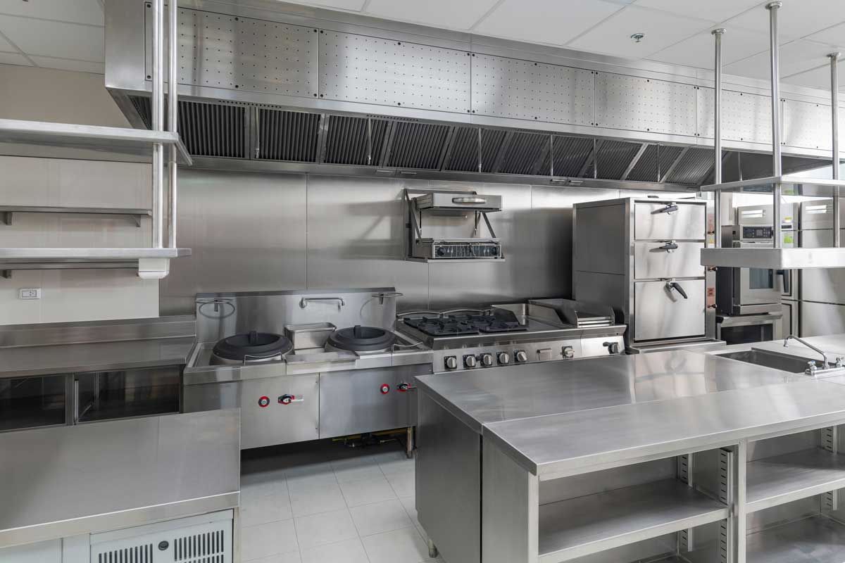 Professional commercial kitchen with stainless steel cooking equipment